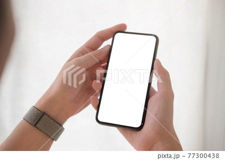 Woman hand holding smartphone with blank white screen 77300438