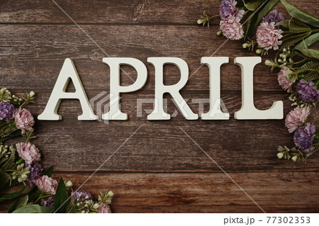 April alphabet letters with flower decoration on wooden background April alphabet letters with flower decoration on wooden background 77302353
