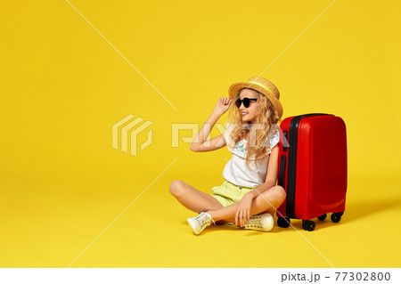 excited little girl with suitcase and passport sitting on floor excited little girl with suitcase and passport sitting on floor 77302800
