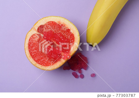 Grapefruit with caviar and banana on violet background 77303787