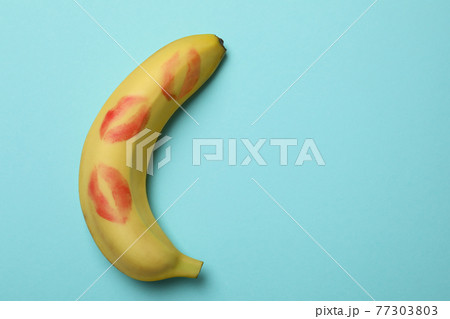Banana with kiss marks on blue background 77303803