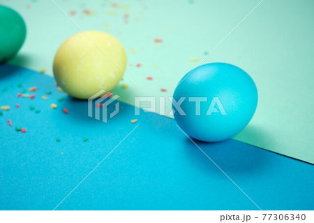 Colored chicken eggs. Easter holiday. Abstraction. Place for text Colored chicken eggs. Easter holiday. Abstraction. Place for text 77306340