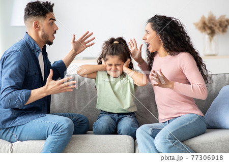 Parental Quarrels. Arab Man And Woman Arguing In Front Of Their Chils 77306918