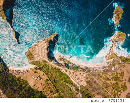 Aerial view of beach with blue ocean in Nusa Penida. Drone view Aerial view of beach with blue ocean in Nusa Penida. Drone view 77312514