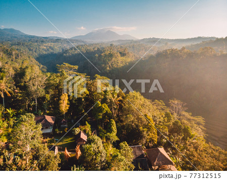 Aerial view of balinese village and mountains in Bali island, Indonesia Aerial view of balinese village and mountains in Bali island, Indonesia 77312515