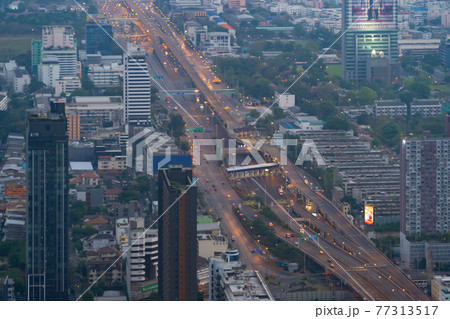 Aerial view of busy cars with traffic jam in the rush hour on highway road street on bridge in Bangkok Downtown, urban city in Asia, Thailand at sunset. Intersection junction. Toll gate in Rama 9 77313517