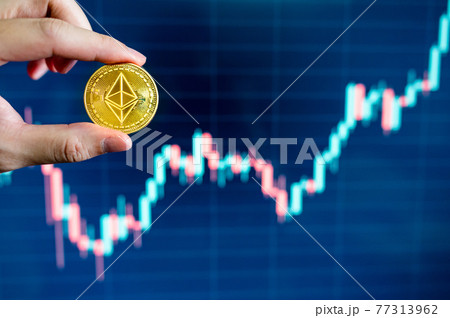 Hand holding gold Ethereum coin 77313962