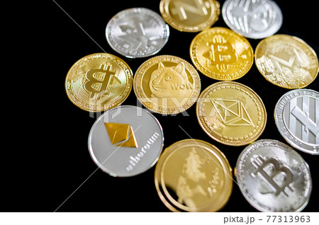 Different cryptocurrency coins on black background Different cryptocurrency coins on black background 77313963