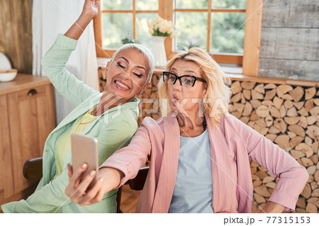 Ladies making faces on camera 77315153