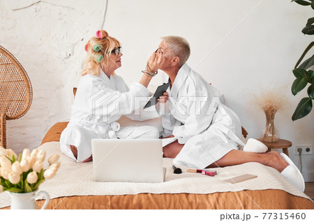 Woman doing make up Woman doing make up 77315460