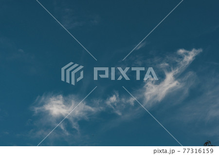 Dark blue sky with small cloud air, cloud evaporates under 77316159