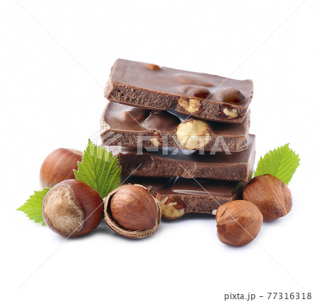 Chocolate with nuts on white backgrounds Chocolate with nuts on white backgrounds 77316318