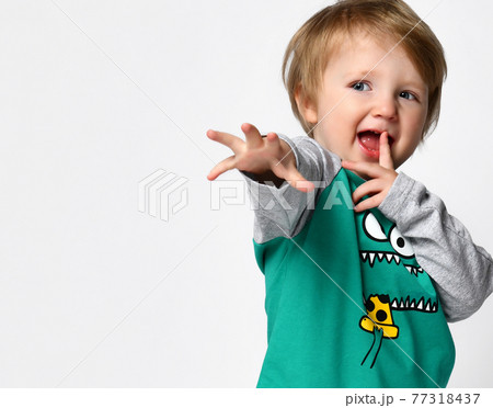 Little preschool toddler boy with hand reaching to Little preschool toddler boy with hand reaching to 77318437