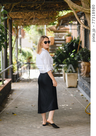 girl in sunglasses walks on European streets girl in sunglasses walks on European streets 77318980