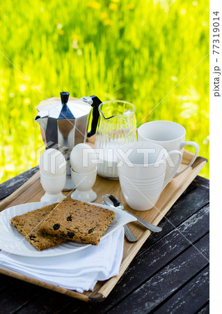 Breakfast for two on an old table in the summer garden 77319014