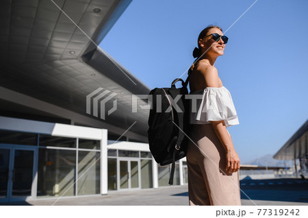 girl tourist with black backpack and sunglasses girl tourist with black backpack and sunglasses 77319242