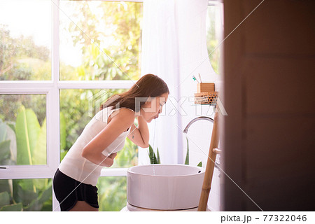 Sick asian woman puking into basin in toilet,Nausea,Indigestible Sick asian woman puking into basin in toilet,Nausea,Indigestible 77322046