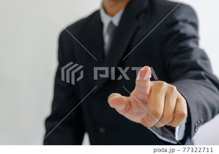business man wearing a suit pointing fingers in front. business man wearing a suit pointing fingers in front. 77322711