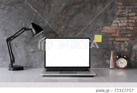 White desk with laptop computer blank white screen, lamp, office supplies, clock in design vase White desk with laptop computer blank white screen, lamp, office supplies, clock in design vase 77327757