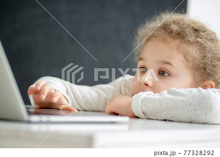 A girl is studying a computer A girl is studying a computer 77328292