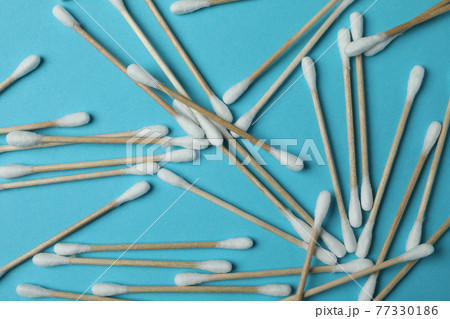 Cotton swabs on blue background, close up 77330186