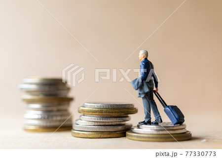 Miniature people businessman with coins 77330773