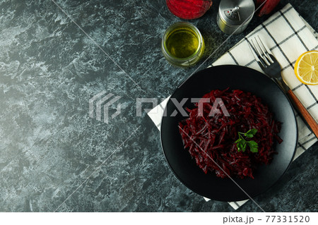 Concept of tasty eating with beet salad on black smoky table 77331520