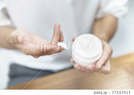 クリームを手に取る男性 クリームを手に取る男性 77332415