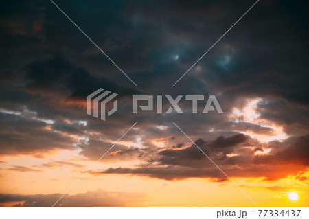 Sunset Cloudy Sky With Fluffy Clouds. Sunset Sky Natural Background. Sunrays, sunray, ray, Dramatic Sky. Sunset In Yellow, Orange, Pink Colors Sunset Cloudy Sky With Fluffy Clouds. Sunset Sky Natural Background. Sunrays, sunray, ray, Dramatic Sky. Sunset In Yellow, Orange, Pink Colors 77334437