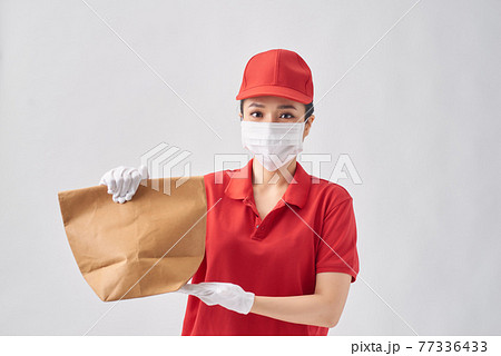 health protection, safety and pandemic concept - delivery woman in protective face mask with food in paper bag over pink background health protection, safety and pandemic concept - delivery woman in protective face mask with food in paper bag over pink background 77336433