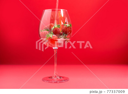 Bright juicy selected strawberries in a large glass with soda. Bright juicy selected strawberries in a large glass with soda. 77337009