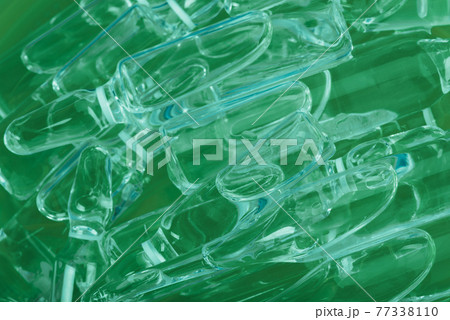 Glass medical ampoule vial for injection. Medicine is liquid sodium chloride with of aqueous solution in ampulla. Close up. Bottles ampule multicolor. 77338110