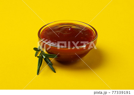 Bowl of barbecue sauce on yellow background Bowl of barbecue sauce on yellow background 77339191