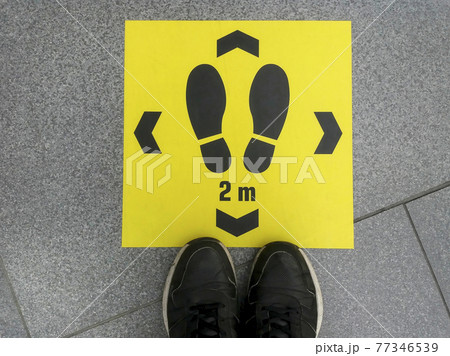 Keep distance sign printed on the floor, safety sticker on ground during Coronavirus COVID-19 outbreak, social distancing in a public area to prevent spreading virus disease infection Keep distance sign printed on the floor, safety sticker on ground during Coronavirus COVID-19 outbreak, social distancing in a public area to prevent spreading virus disease infection 77346539