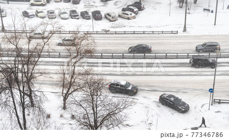 above view of car traffic at street in snowfall above view of car traffic at street in snowfall 77346786