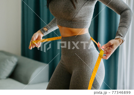 slim Woman waist Measuring With Tape at home slim Woman waist Measuring With Tape at home 77346899