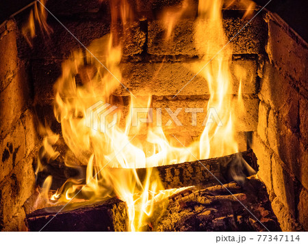 fire in stone hearth 77347114