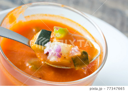 Gazpacho soup in glass on white wooden background 77347665