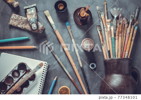 Paintbrush and tubes with painter tools at abstract table background texture. Art painter concept 77348101