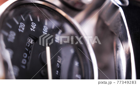 Close shot of black speedometer on the chrome painted motorcycle 77349283