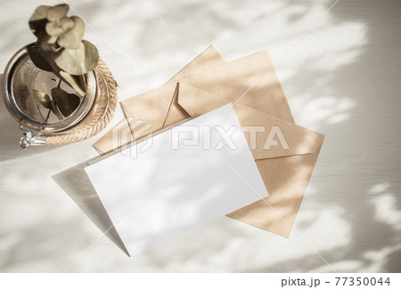 blank greeting card  invitation mockup with craft paper envelope  feminine still life composition 77350044
