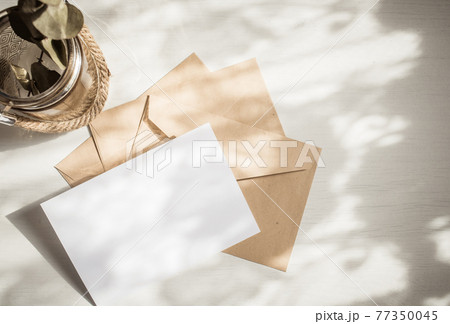 blank greeting card  invitation mockup with craft paper envelope  feminine still life composition 77350045