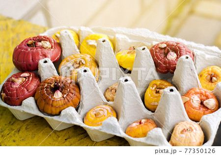 Gladiolus tubers in egg cardboard trays. Germination of corms using a new technique. Growing and planting plants in spring. Selective focus Gladiolus tubers in egg cardboard trays. Germination of corms using a new technique. Growing and planting plants in spring. Selective focus 77350126