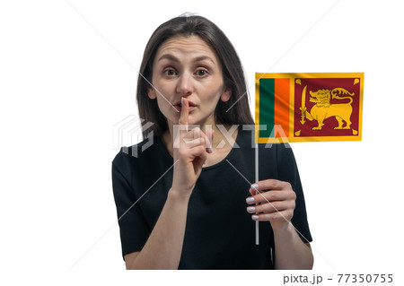 Happy young white woman holding flag of Sri Lanka and holds a finger to her lips isolated on a white background 77350755
