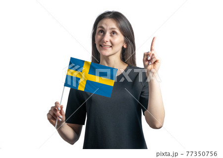 Happy young white woman holding flag of Sweden and points thumbs up isolated on a white background Happy young white woman holding flag of Sweden and points thumbs up isolated on a white background 77350756
