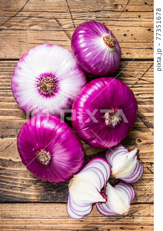 Sweet red onion on a wooden table. Wooden background. Top View Sweet red onion on a wooden table. Wooden background. Top View 77351678