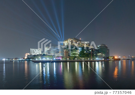 Siriraj Piyamaharajkarun Hospital or SiPH buildings with laser light show at Chao Phraya River in Bangkok City at night, Thailand. Siriraj Piyamaharajkarun Hospital or SiPH buildings with laser light show at Chao Phraya River in Bangkok City at night, Thailand. 77357046