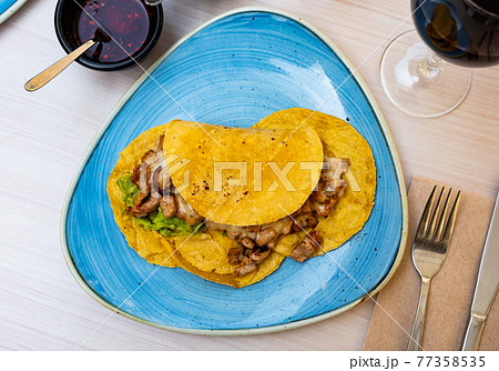 Mexican tacos with chicken, guacamole and sauces Mexican tacos with chicken, guacamole and sauces 77358535