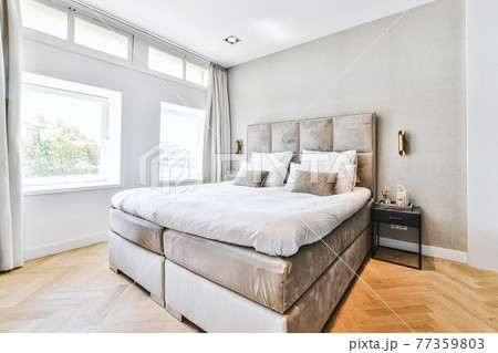 Simple bedroom with cozy bed in flat 77359803