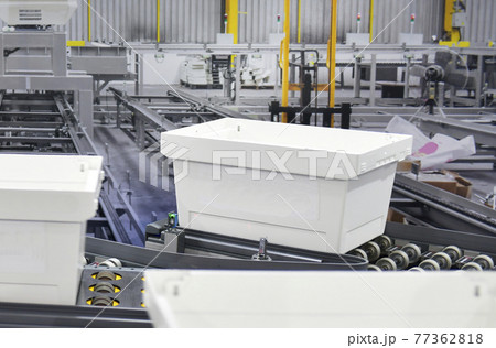 White plastic box on conveyor belt. parcels transportation system concept	 77362818